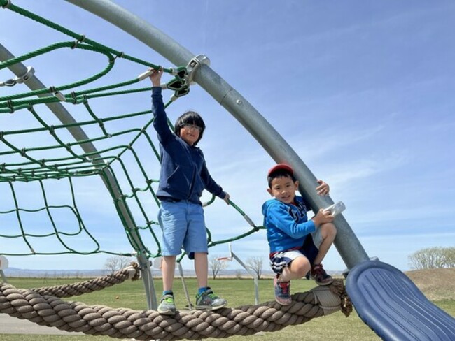 2 students playing on a playground